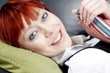 Young female lying on a sofa and relaxing in her living room.