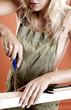 Foto: Woman screwing screw into a wood Woman screwing screw into a wood