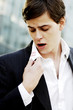 Businessman looking at the lipstick stain on his collar