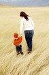 Mother and daughter holding hands while walking together
