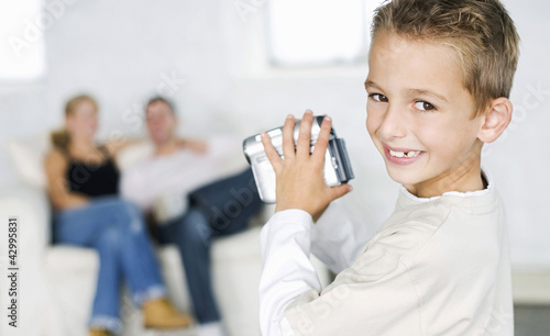Photo: Boy filming parents with camcorder Boy filming parents with camcorder