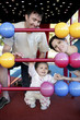Parents and daughter playing with abacus in the playground