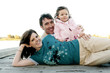 Couple and their daughter posing for the camera