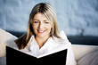 A business lady smiling while reading