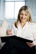 A business lady showing satisfaction while writing
