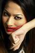 Photo: Woman rubbing off her lipstick with her hand Woman rubbing off her lipstick with her hand