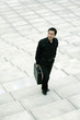 Businessman with briefcase standing at the staircase