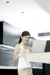 Woman using laptop in the kitchen
