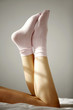 Woman wearing socks relaxing on bed