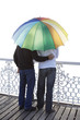 Guys sharing umbrella