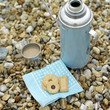Vacuum flask and cookies on a tree stump