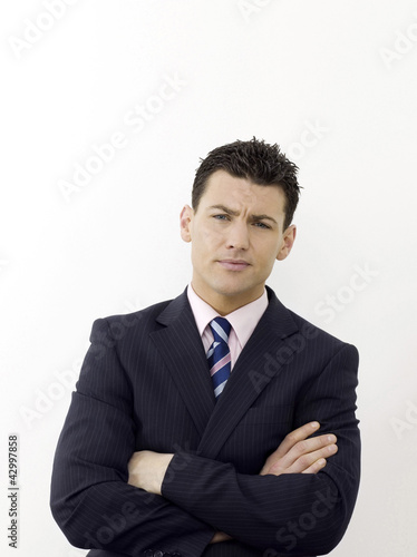 Photo: Businessman with hands across chest Businessman with hands across chest