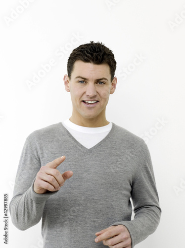 Photo: Man smiling and pointing at camera Man smiling and pointing at camera