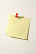 A note fastened with a map pin