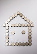 Coins making a house shape