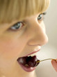 Pretty girl eating a cherry
