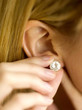 Putting on an earring