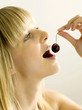 Pretty girl eating a cherry