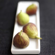 Close up of four figs on a small plate