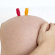 Gummi bears on a pregnant woman's stomach