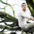 A man sitting on a tree