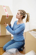 Woman stacking up sealed boxes