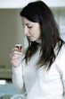 A woman with cough syrup in hand