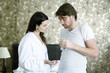A woman giving the man medication