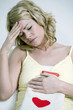 A woman having headache and holding a hot water bottle