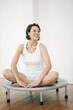 Woman sitting on a trampoline