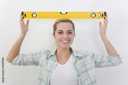 Photo: Woman with spirit level on her head Woman with spirit level on her head