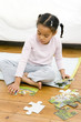 Girl playing with jigsaw puzzle