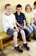 Children sitting on the bench smiling