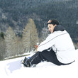 Male snowboarder smiling while looking away