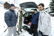 Winter sports player posing beside their jeep