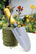 Hand trowel resting on a roll of twine