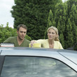 Photo: Man and woman washing car together Man and woman washing car together