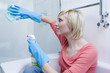 Woman cleaning the glass in the bathroom