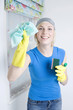 Woman with rubber gloves holding cleaning equipment