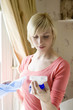 Woman reading instructions on hand sprayer