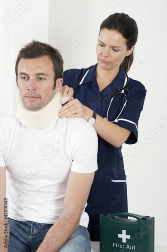 Photo: Female nurse treating a patient Female nurse treating a patient