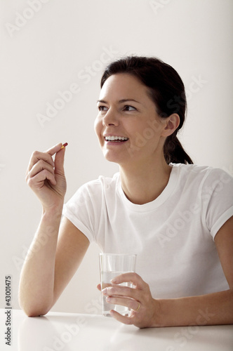 Photo: Woman about to take her medication Woman about to take her medication