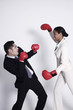 Businesswoman and businessman fighting
