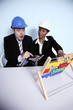 Businessman in shock while calculating, businesswoman looking at him