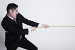 Businessman pulling rope