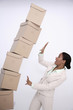 Stacked boxed about to drop on businesswoman