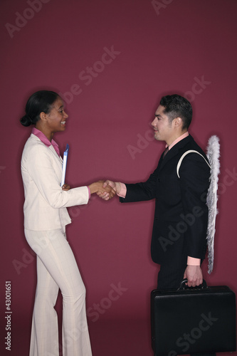 Photo: Businessman and businesswoman shaking hands Businessman and businesswoman shaking hands