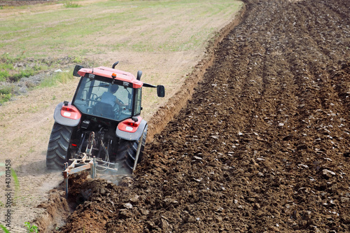 Photo: Tractor plowing the field Tractor plowing the field