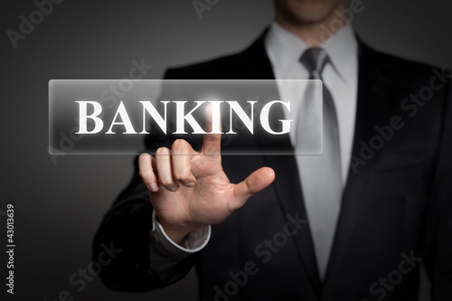 Photo: Mann drückt touchscreen button - banking Mann drückt touchscreen button - banking