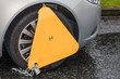 Yellow wheel clamp on illegally parked car